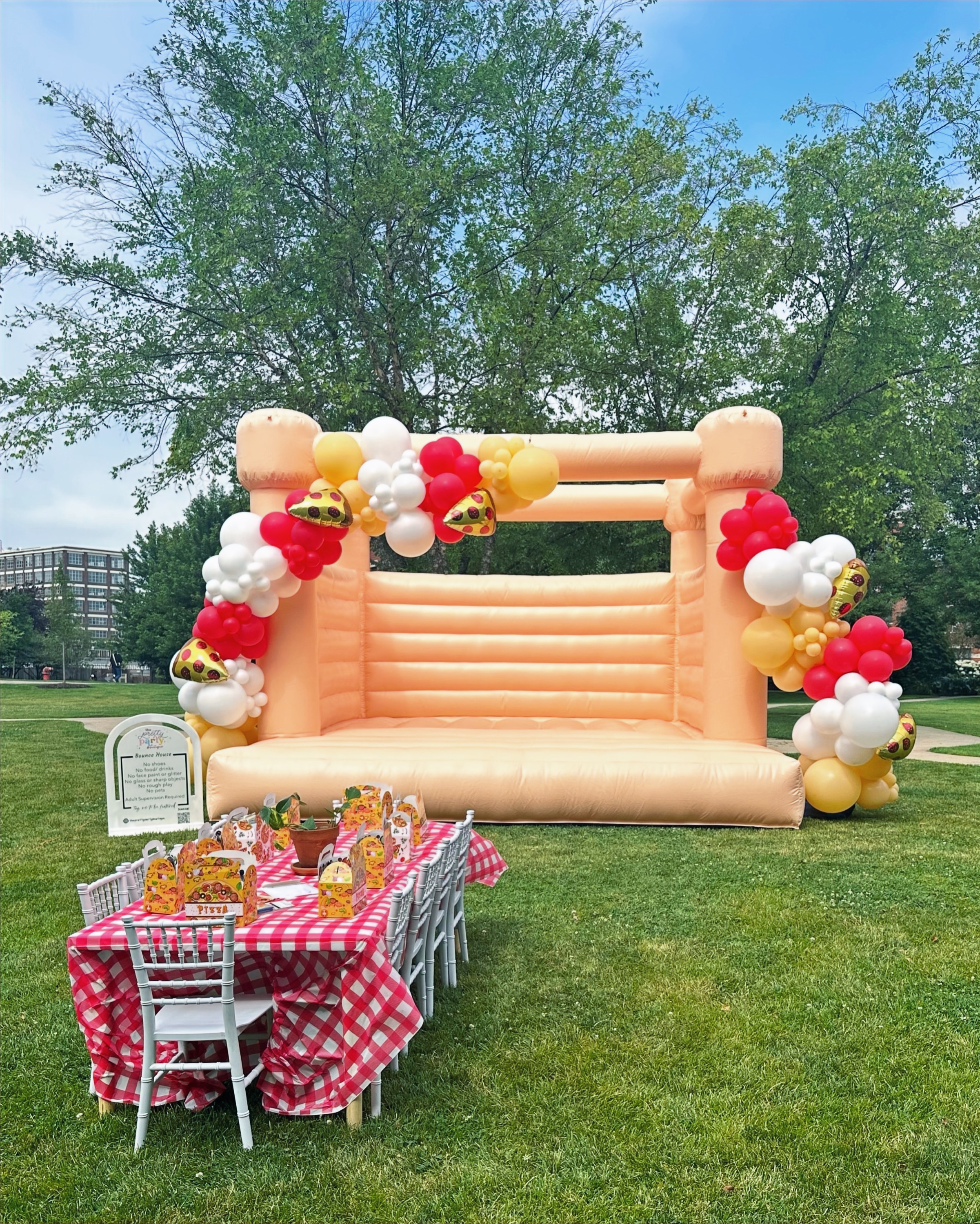 Pizza themed bounce house with party table setup